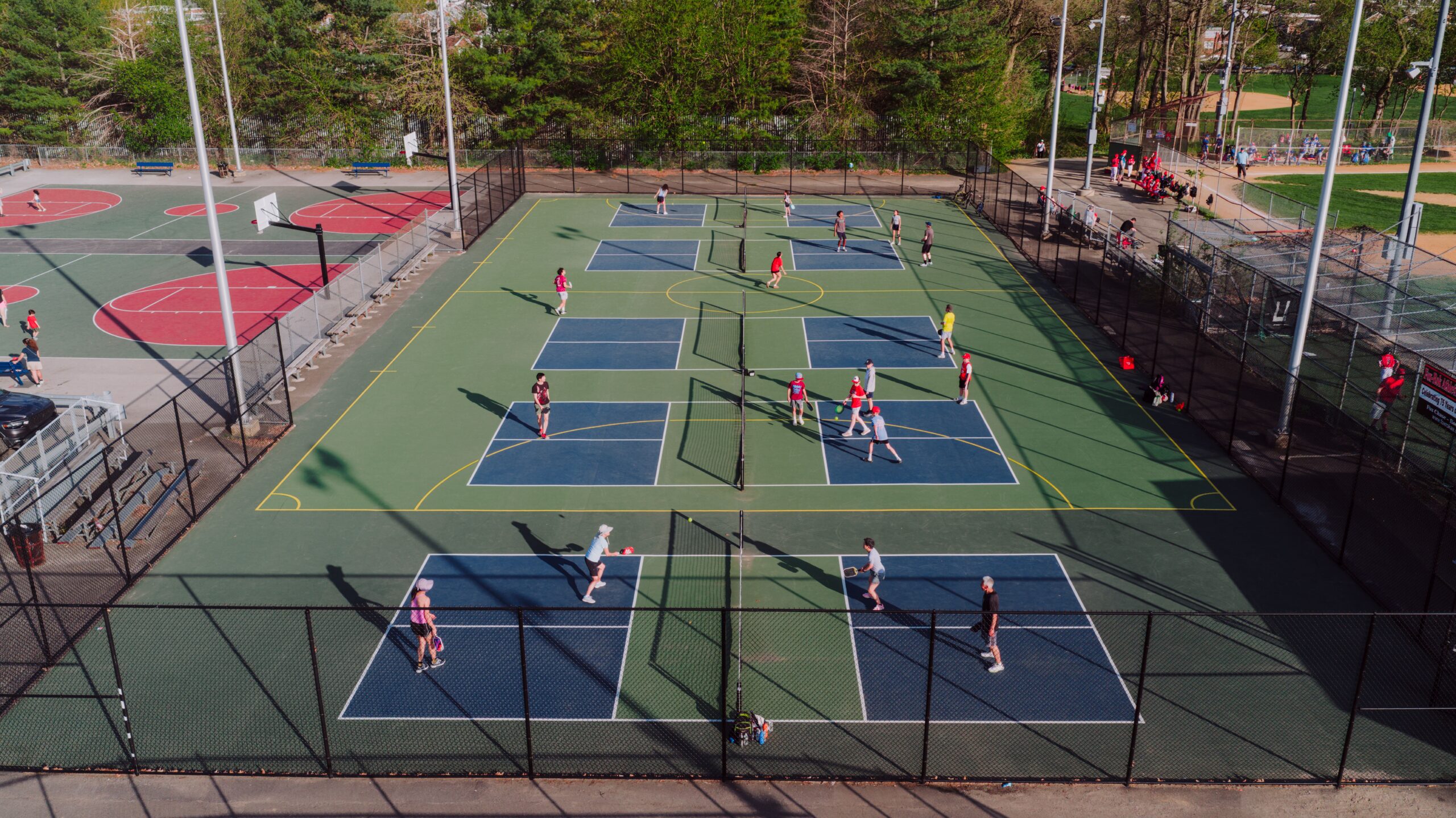 People playing pickleball on multiple courts