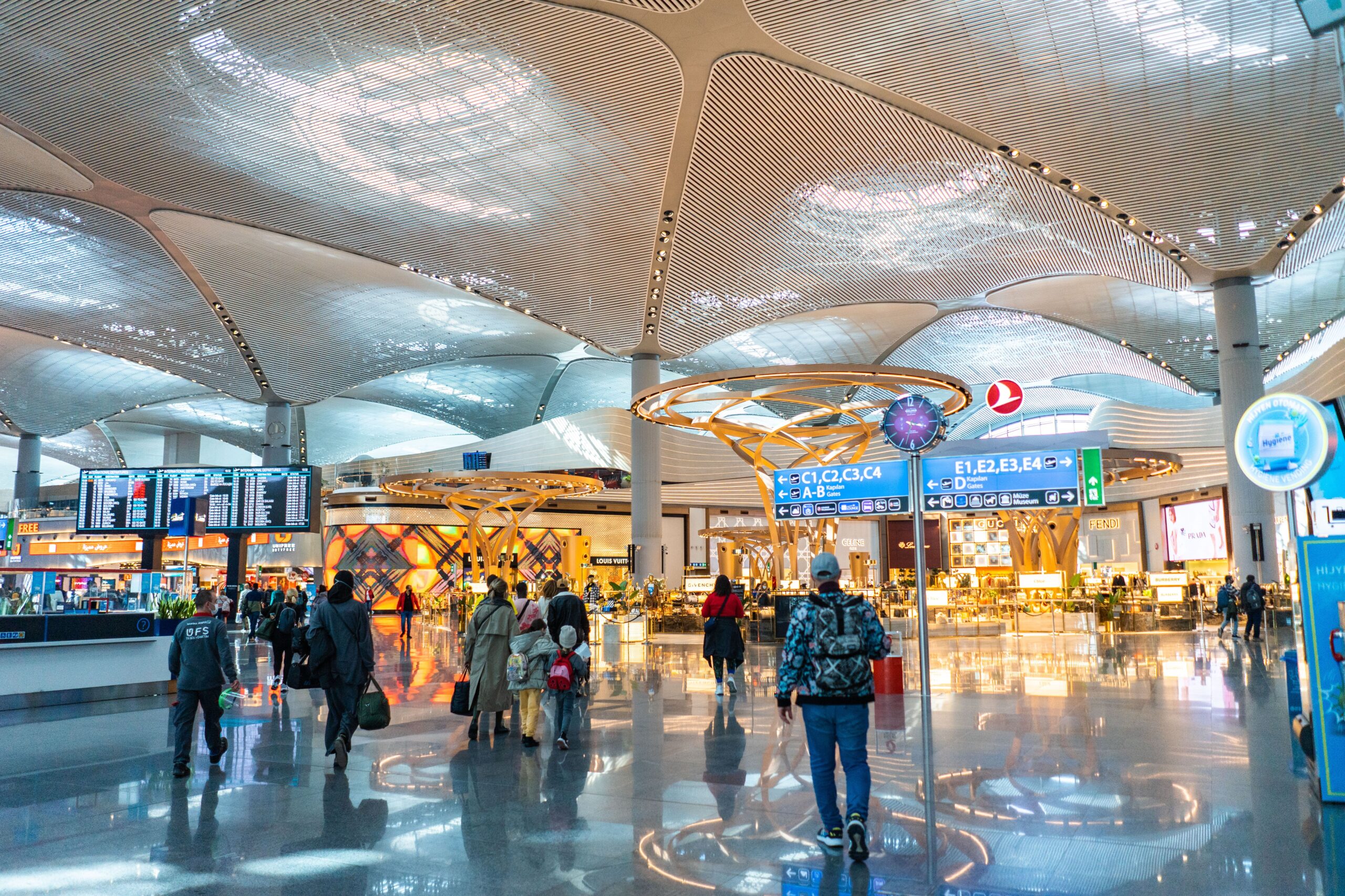 An airport terminal with some shops in the background